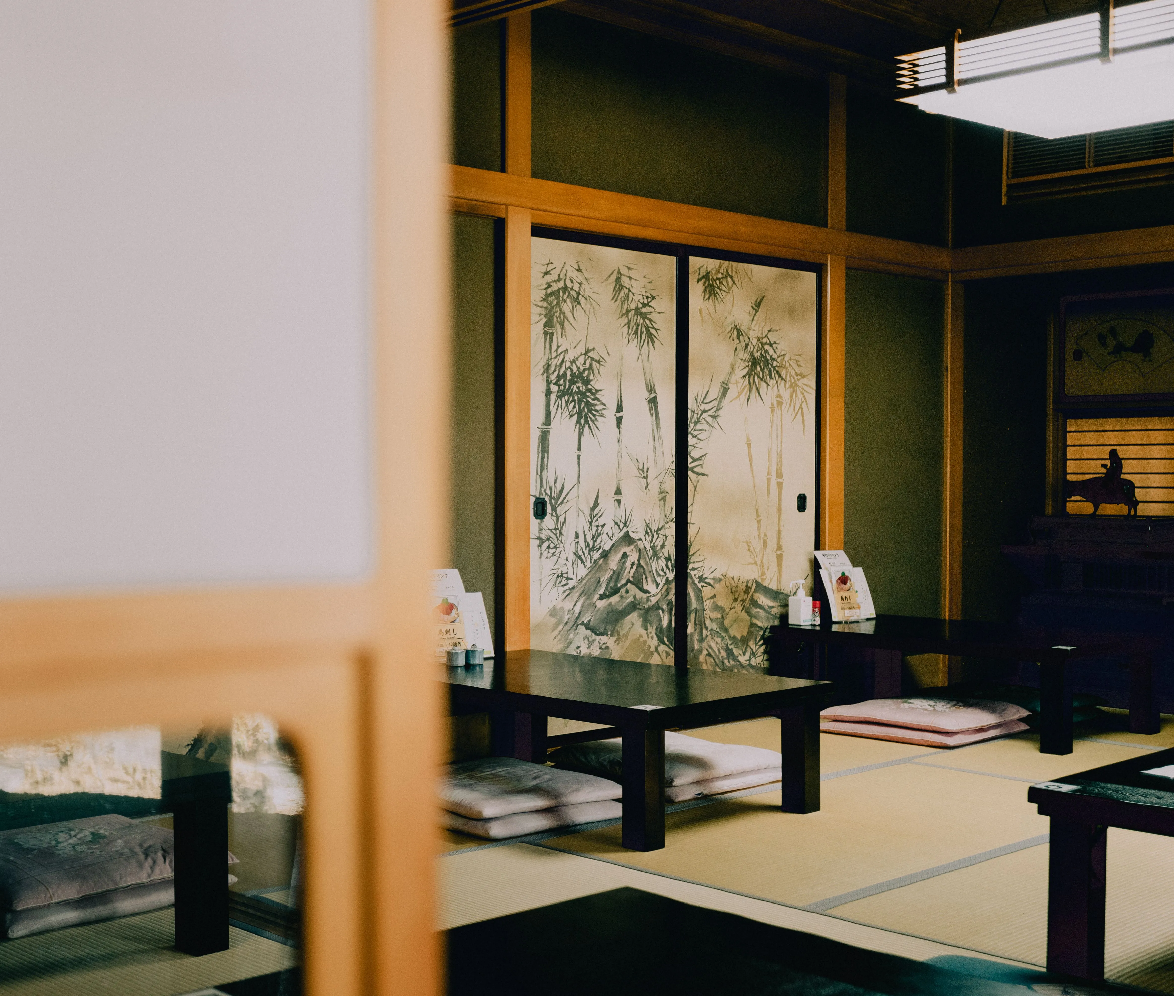 A lantern-lit ryokan street on a rainy evening in rural Kyoto